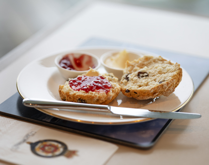 A scone with jam and cream