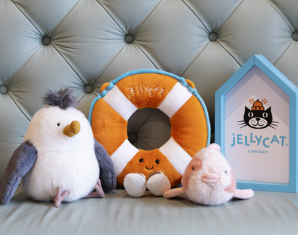 A selection of seaside Jellycat plush toys, there is a seagull, life buoy and fish. 