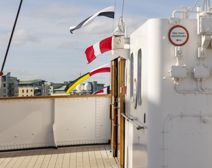 On the Bridge, colourful flags are flying in the wind and sunshine. 