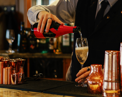 A glass of Moet & Chandon is being poured at the bar in The Lighthouse Restaurant. 