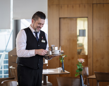 Christopher in the Tearoom serving tea.