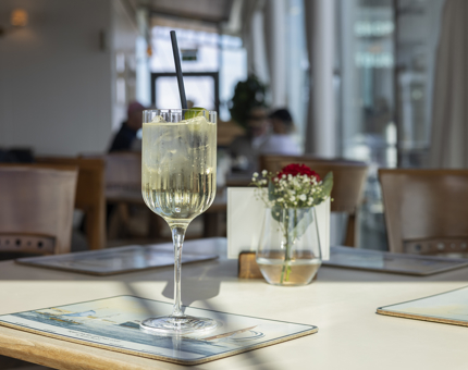 A tall glass containing a Spritz on a table in the Royal Deck Tearoom. 