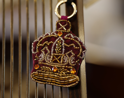 A crown shaped bag charm. 