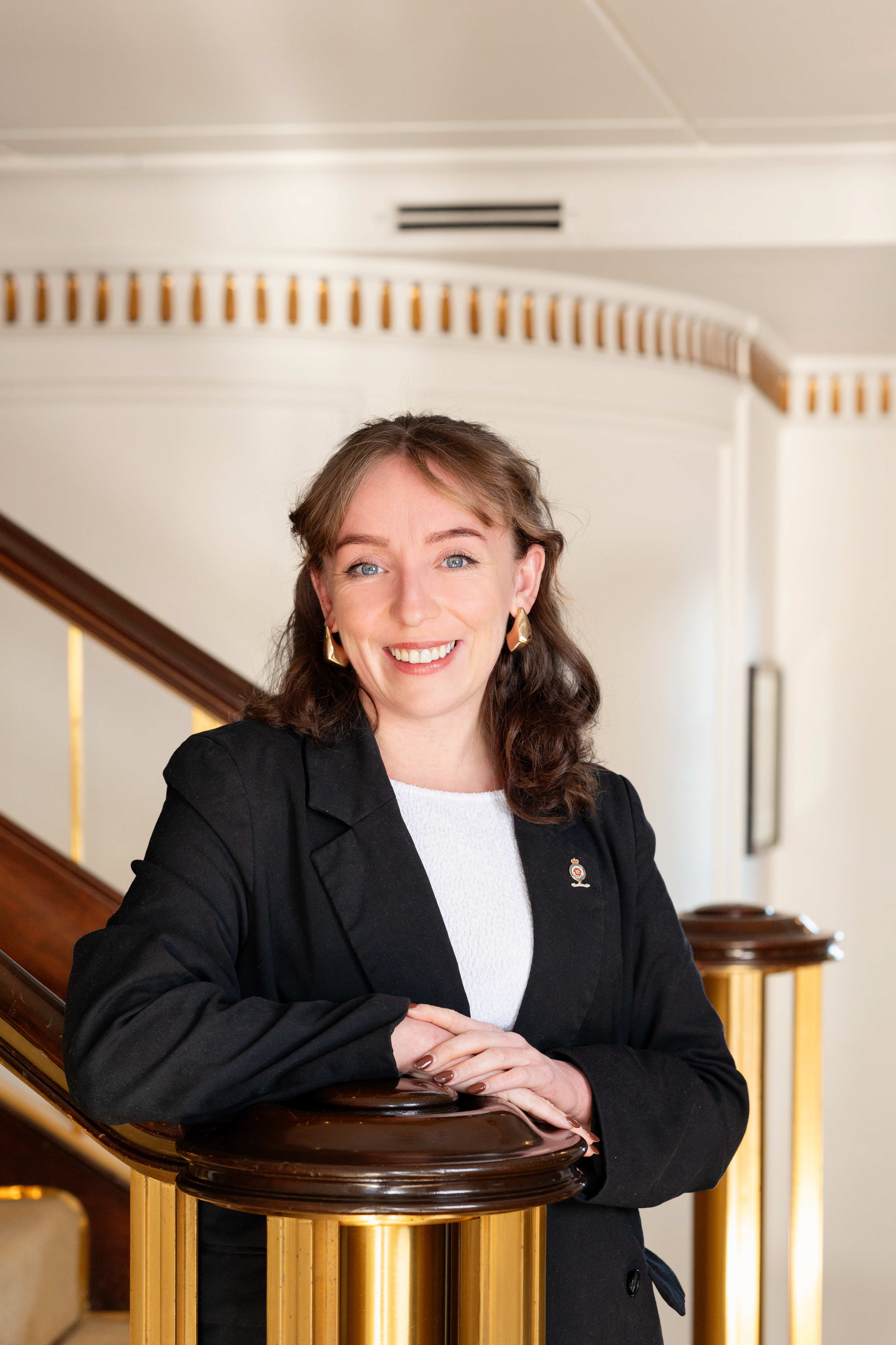 Woman standing on a staircase for a portrait.