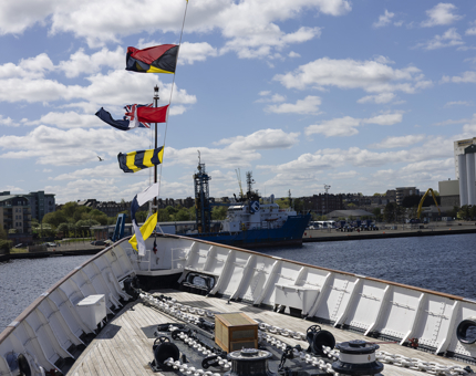 Flags flying above Britannia in the Port of Leith. 