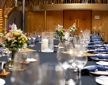 A close up of a long table in the Ballroom set for an exclusive dinner on board. 