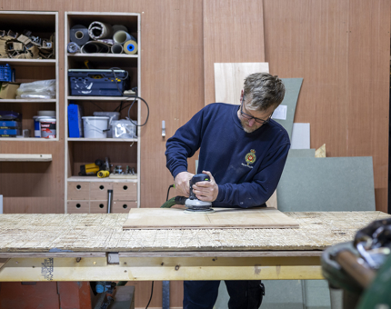 A Maintenance man cutting panels for a cabin refurbishment on Fingal in Leith. 