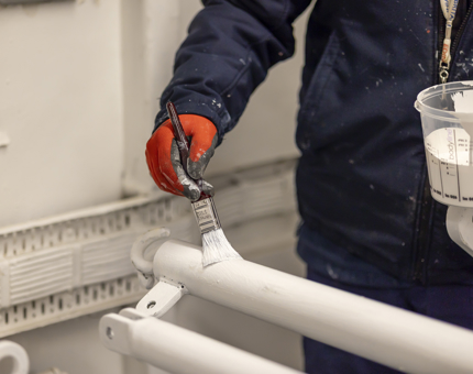 A closer look at pole being painted white. 