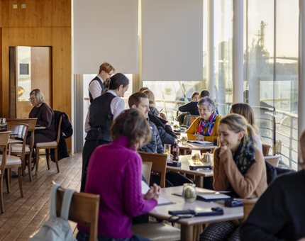 In the Royal Deck Tearoom in the Port of Leith, visitors are sitting at the tables waiting to be served. 