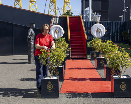 A Housekeeper is pruning the plants at the Royal Brow in Leith. 