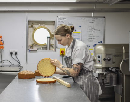 A Chef in the Galley is preparing Victoria sponge cakes. 
