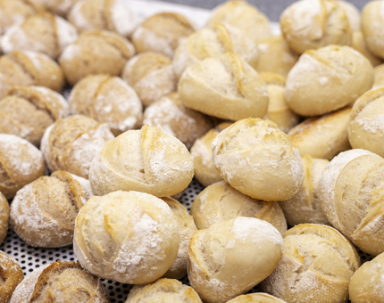 a close up of a tray of bread rolls fresh out of the oven. 