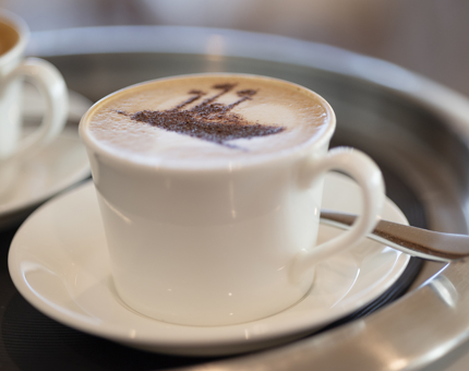 A cappuccino with a chocolate stencil of Britannia on top
