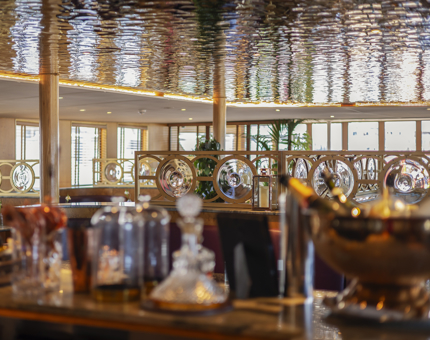 A focus on the nautical glass details and shimmering ceiling of The Lighthouse Restaurant. 
