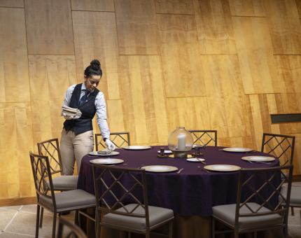 A Hospitality Server setting the tables in the Ballroom.