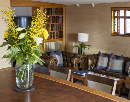 The Skerryvore sitting room area, there is a vase with yellow flowers in it. 