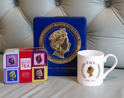 Two Tea Caddies with Queen Elizabeth II image on it and a Queen Elizabeth II commemorative mug. 