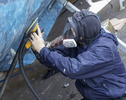Ben sanding the Admiral's Fast Motor Launch