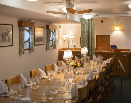 A dining table is set for dinner in the Officer's Wardroom aboard Britannia.