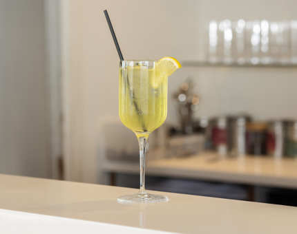 A glass of limoncello spritz sitting on the bar of the Tearoom abord Britannia. 