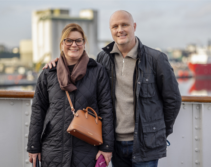 A couple pose for a photo on the Bridge