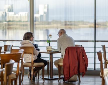 Visitors in Tearoom enjoying the waterfront views