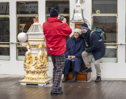 Tim taking photo of couple at bell