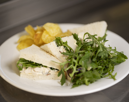 A delicious Chicken, cured bacon, rocket, horseradish & chive mayonnaise sandwich.