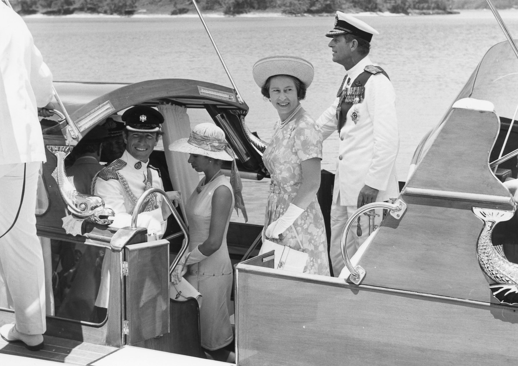 A woman and a man standing inside a boat with other family members
