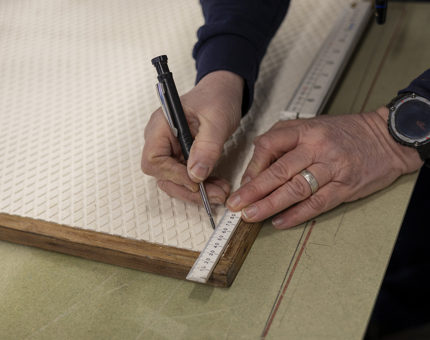 A maintenance team member is measuring tread for the Royal Barge. 