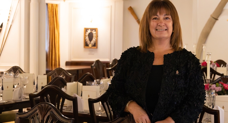 Diane, a member of the Events team standing by a table in Britannia's State Dining Room. 