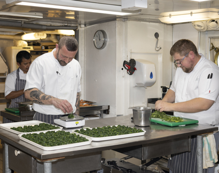 Evening Event Dinner Preparation Underway In The Onboard Galley by the chefs. 