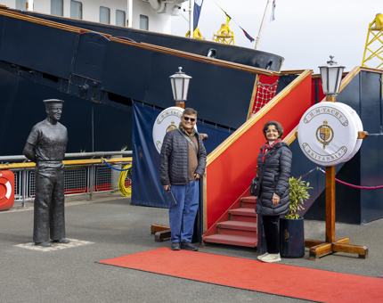 A man and a woman are posing for a photo at the Royal Brow on Britannia's quayside. 