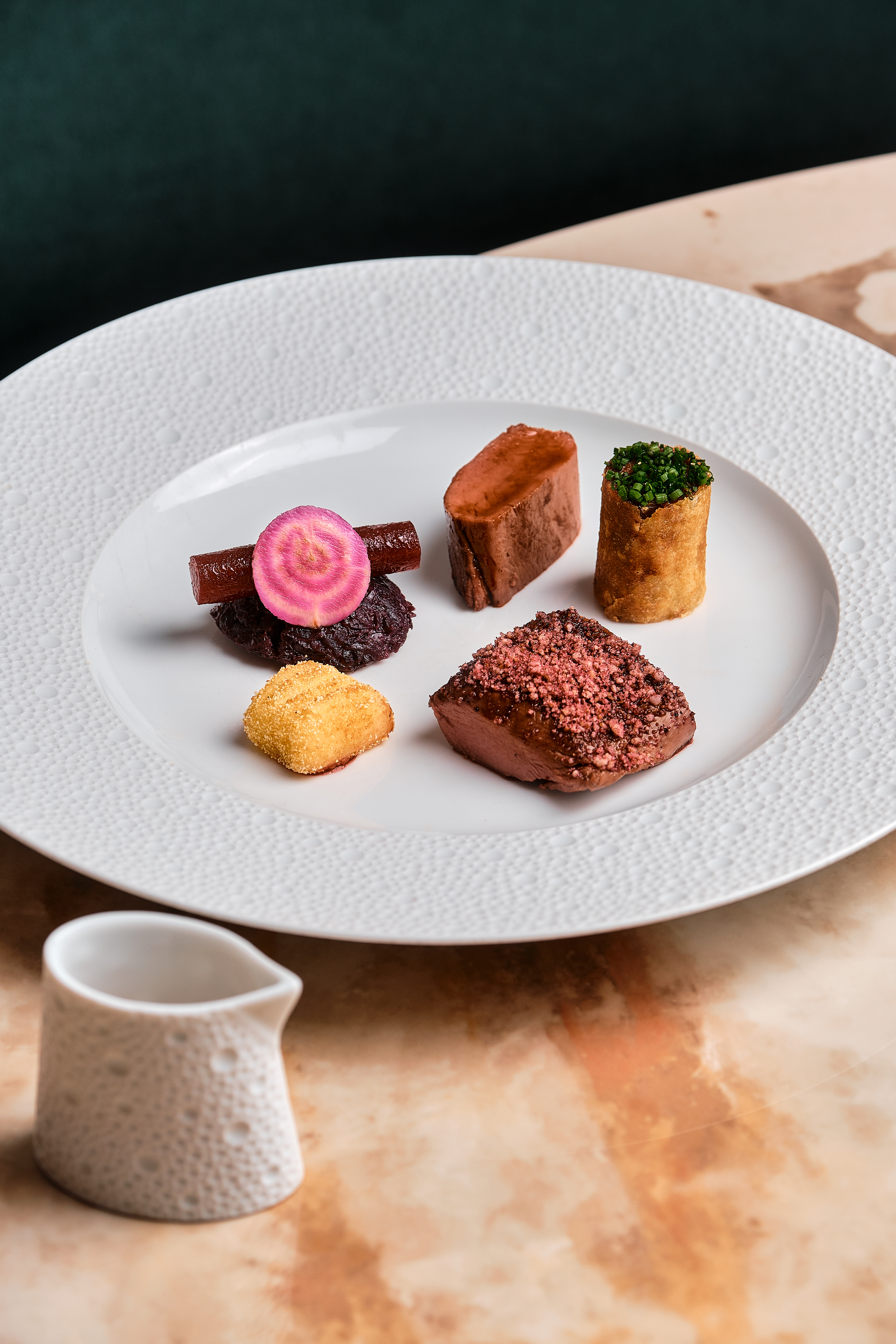 A white plate contains a selection of bite-sized food