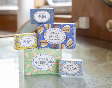 Five bars of soaps with colourful and brightly coloured designs in them. 
