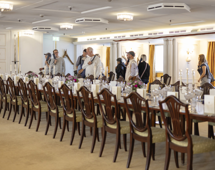 Visitors exploring the Dining Room aboard The Royal Yacht Britannia. 