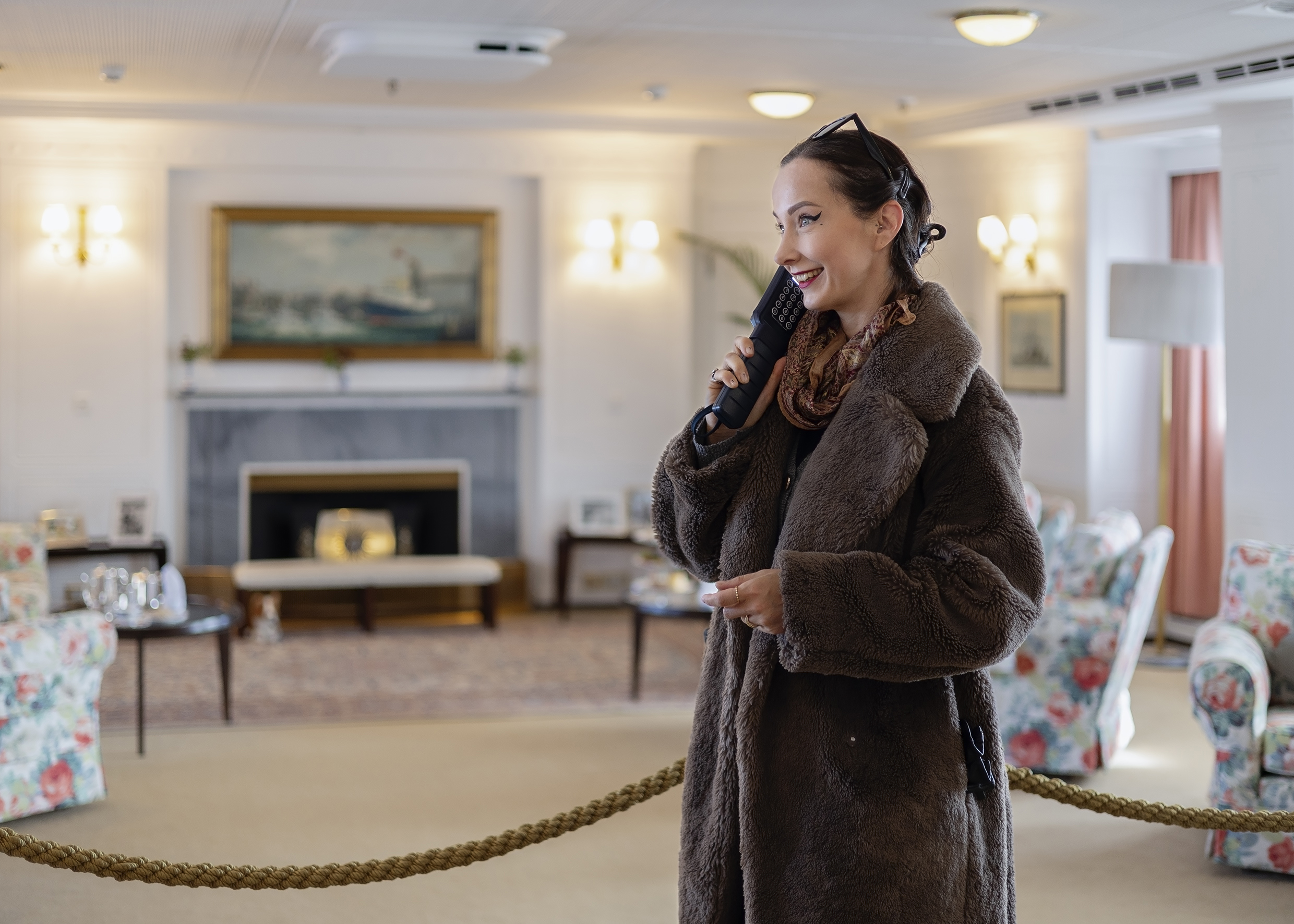 Visitor Listening To The Audio Guide Handset In The Drawing Room Aboard Britannia