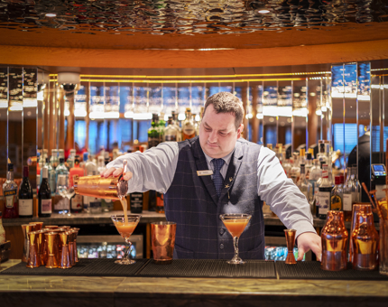 A bar tender making a Pole Star Martini on Fingal. 