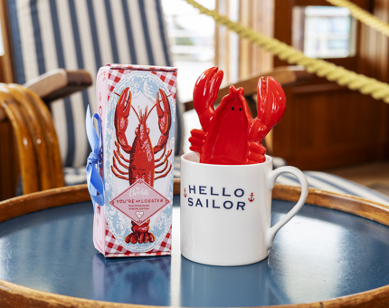 A mug, lobster shaped trinket dish and box of chocolates on display, The Royal Yacht Britannia. 