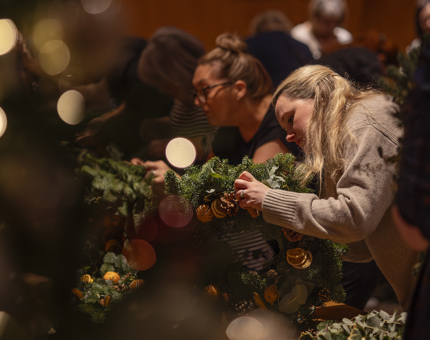 In the Ballroom, guests are making Christmas wreaths. 