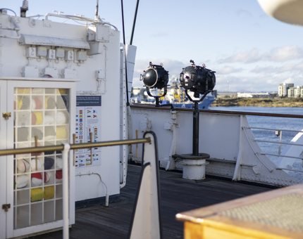 The Bridge of Britannia on a sunny day, with a focus on the signal lights. 