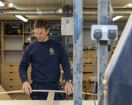 A maintenance team member manufacturing a template in the workshop. 