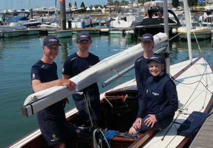 The crew members of Bluebottle on the boat smiling 