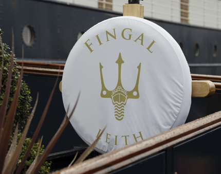 The entrance to Fingal Hotel in Leith, there is a perry buoy with a white cover featuring a gold trident design and the word Fingal Hotel. 