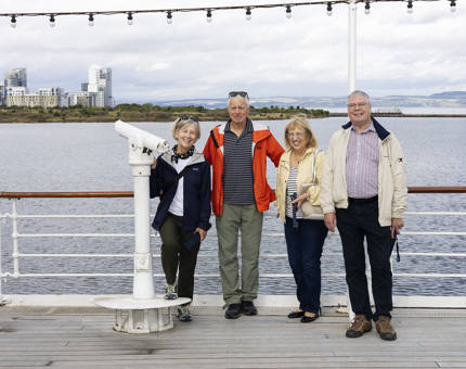 Visitors Posing For A Photo By The Telescope On The Verandah Deck in Leith. 